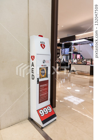 AED or Automated External Defibrillator installed on wall in shopping mall as first aid in heart attack situation. 132047509