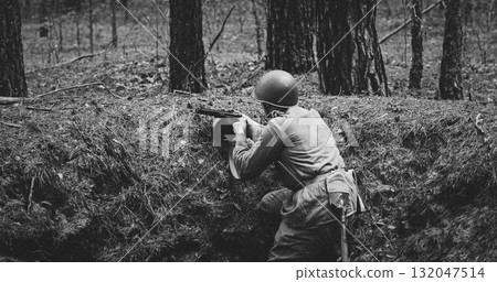 Black and White Soldier Aiming in the Historical Forest. Soviet Russian Soldier Aiming With Rifles. Soldiers Shoots With Rifle. Soviet Russian Soldier Uniform 132047514