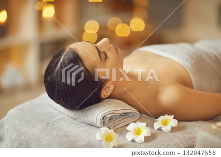Relaxed young woman getting facial skin care beauty treatments at a modern spa salon Relaxed young woman getting facial skin care beauty treatments at a modern spa salon 132047558