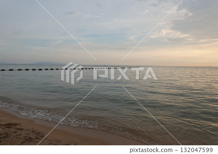 Calm Ocean Scene at Sunset with buoy in the sea 132047599