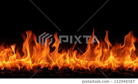 Bright orange flames dancing against a black background Bright orange flames dancing against a black background 132048387