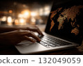 Economist analyzing international trade data on laptop 132049059