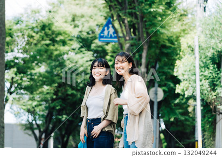 Female friends walking while chatting 132049244