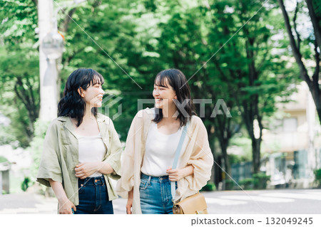 Female friends walking while chatting 132049245