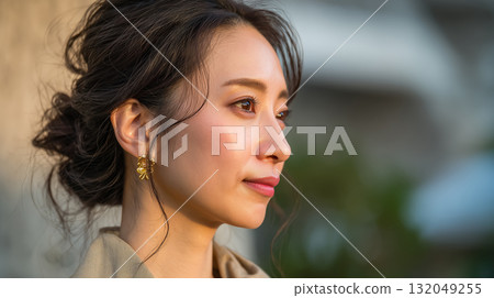A woman's profile bathed in the sunset and her introspective beauty 132049255