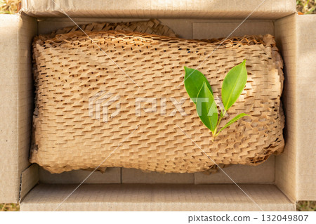 Green leaf on eco friendly brown paper honeycomb wrap for product packaging parcel carton box 132049807