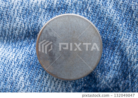 Old metal button closeup on blue jeans 132049847