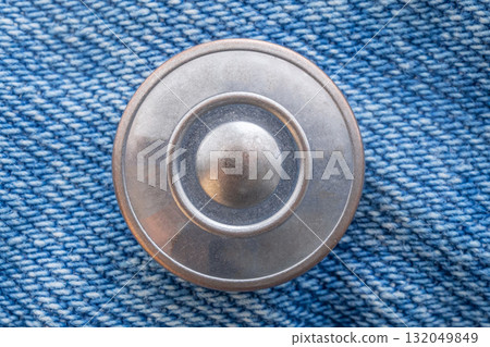 Old metal button closeup on blue jeans Old metal button closeup on blue jeans 132049849
