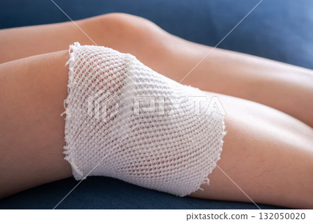 wound dressing bandage on child knee after fall on the ground 132050020