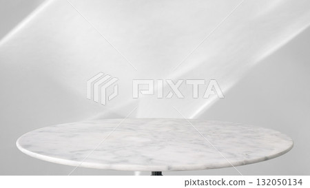 Round marble table top with abstract shadow drop on white wall background for mockup product display Round marble table top with abstract shadow drop on white wall background for mockup product display 132050134