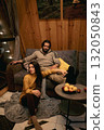 Couple relaxing indoors in a cozy wooden cabin during a quiet evening 132050843