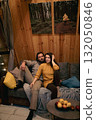 Cozy moments shared by a couple in a rustic cabin during a chill evening indoors 132050846