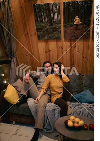 Cozy moments shared by a couple in a rustic cabin during a chill evening indoors Cozy moments shared by a couple in a rustic cabin during a chill evening indoors 132050846