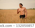 Man in a wheat field enjoys nature and reflects during a warm summer day 132050857