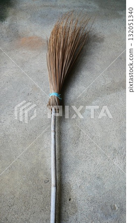 Traditional Asian Coconut Leaf Midrib Broom on Concrete Floor 132051340