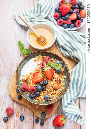 Healthy breakfast granola with fresh berries and honey Healthy breakfast granola with fresh berries and honey 132052010