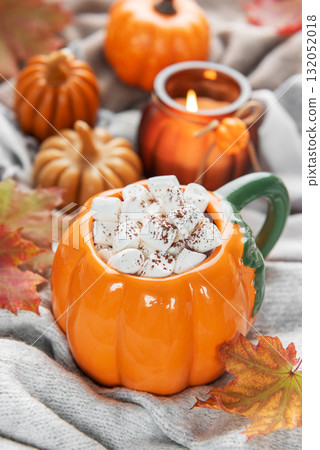Pumpkin mug of hot chocolate with marshmallows cozy autumn scene Pumpkin mug of hot chocolate with marshmallows cozy autumn scene 132052018