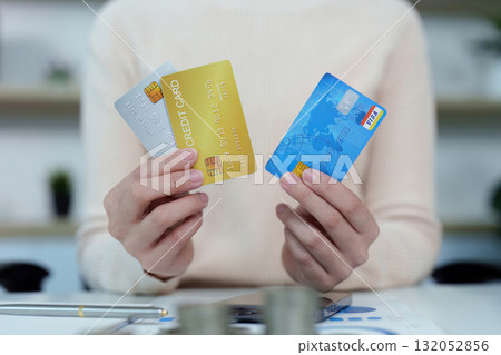Credit Management. Woman holding multiple credit cards, showcasing financial options. Credit Management. Woman holding multiple credit cards, showcasing financial options. 132052856