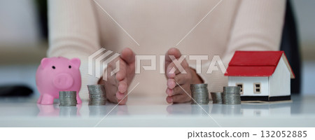 Financial planning. Budgeting with coins and a piggy bank for savings. 132052885