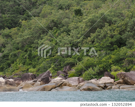Fitzroy Island – a tranquil cove surrounded by green forests and rocky shores Fitzroy Island – a tranquil cove surrounded by green forests and rocky shores 132052894