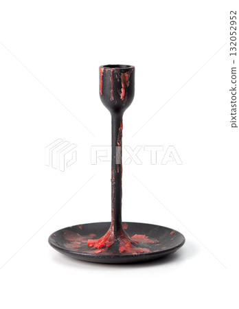 Black metal candle holder covered with red wax drips, isolated on white background, gothic style object. Black metal candle holder covered with red wax drips, isolated on white background, gothic style object. 132052952
