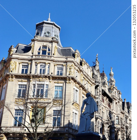 David Teniers Younger statue standing in front of ornate historic buildings on Leysstraat, Antwerp, under a clear blue sky. Belgium David Teniers Younger statue standing in front of ornate historic buildings on Leysstraat, Antwerp, under a clear blue sky. Belgium 132053235