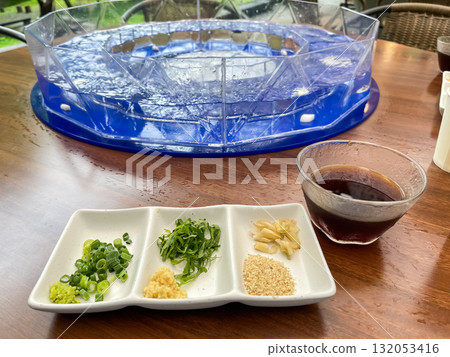 Nagashi somen. The soup and condiments used to eat somen. A typical Japanese summer sight. Nagashi somen. The soup and condiments used to eat somen. A typical Japanese summer sight. 132053416