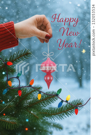 Happy New Year ornament on Christmas tree branch Happy New Year ornament on Christmas tree branch 132053534