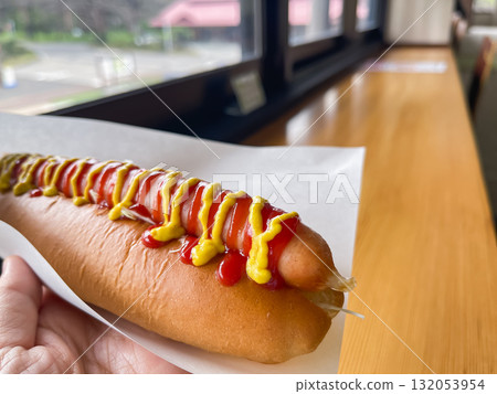 多汁的熱狗，上面淋著番茄醬和芥末醬。 132053954