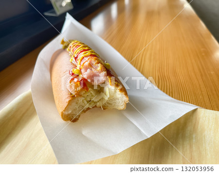 A juicy hot dog topped with tomato ketchup and mustard sauce. A juicy hot dog topped with tomato ketchup and mustard sauce. 132053956