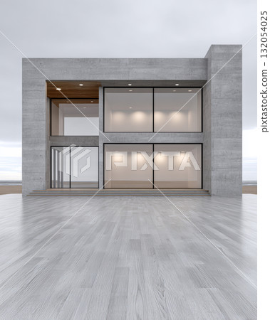 Modern concrete building with large windows and sleek design near the ocean on a cloudy day 132054025