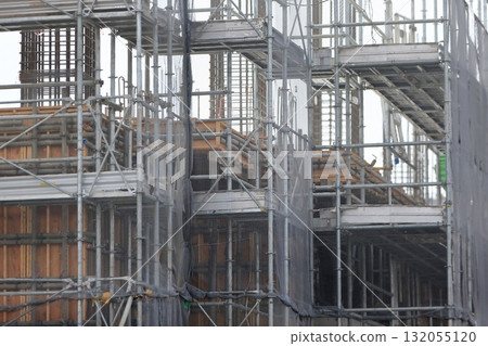 Apartment building construction site (external scaffolding) image during framework construction Apartment building construction site (external scaffolding) image during framework construction 132055120