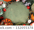 Halloween green frame background flatlay with pumpkins and party decor 132055378