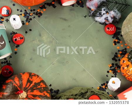 Halloween green frame background flatlay with pumpkins and party decor Halloween green frame background flatlay with pumpkins and party decor 132055378