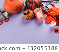 Halloween purple frame background flatlay with pumpkins and party decor 132055388