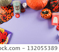 Halloween purple frame background flatlay with pumpkins and party decor 132055389
