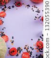 Halloween purple frame background flatlay with pumpkins and party decor 132055390