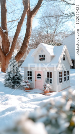 A cozy house with a pink door stands by an ice rink, decorated for the season, amidst tall buildings on a winter day A cozy house with a pink door stands by an ice rink, decorated for the season, amidst tall buildings on a winter day 132055422