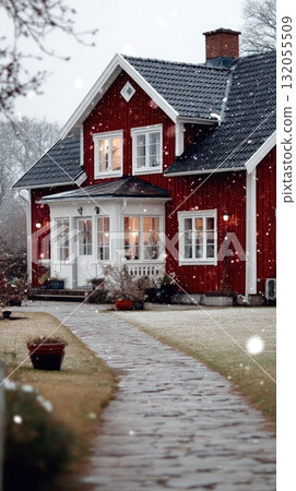 A cozy red house glows with warmth as snow blankets the landscape during a peaceful winter evening, creating a serene atmosphere A cozy red house glows with warmth as snow blankets the landscape during a peaceful winter evening, creating a serene atmosphere 132055509