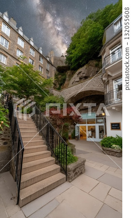 Stars twinkle above a majestic structure, creating a magical atmosphere in the peaceful courtyard below, inviting wonder and exploration 132055608