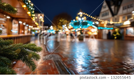A bright Christmas tree stands at the center of a holiday market, adorned with glowing lights and surrounded by festive stalls and visitors 132055645