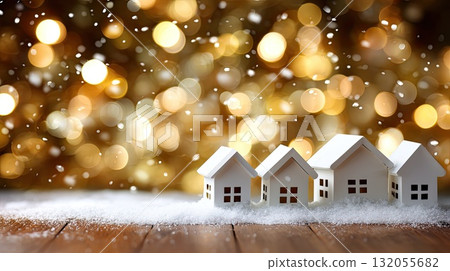 Small white houses sit on a layer of snow, with shimmering lights creating a warm and festive feel in the background during winter Small white houses sit on a layer of snow, with shimmering lights creating a warm and festive feel in the background during winter 132055682