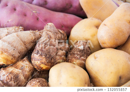 Three types of potatoes held in a colander 132055857