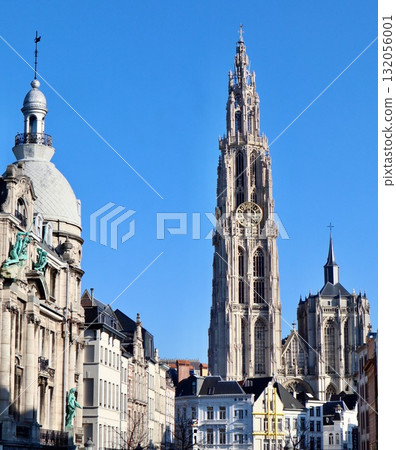 Cathedral of Our Lady's gothic spires and bell tower dominating the skyline, surrounded by traditional urban architecture in Antwerpen, Belgium 132056001