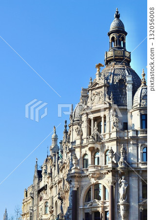 Antwerp architecture with intricate details, ornate facades, and a dominant dome against a clear blue sky 132056008