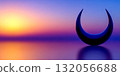 Sunset over a serene landscape with a crescent moon sculpture on a calm lake 132056688