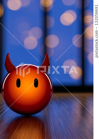 Cute devil figurine with a glowing orange finish placed on a wooden surface under soft blue lighting 132056691