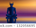Dark figure in meditation poses against a vibrant sunset backdrop with smooth water reflections 132056695