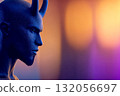 Profile view of a blue-skinned humanoid with horns against a colorful blurred background at night 132056697