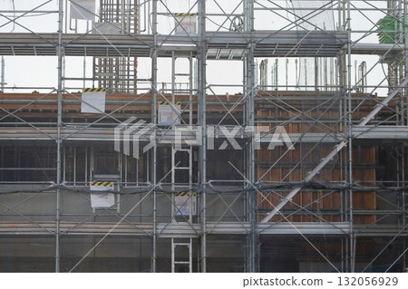 Apartment building construction site (external scaffolding) image during framework construction 132056929